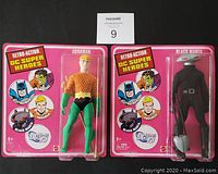 Front view of Aquaman and Black Manta vintage action figures in their sealed blister packaging with Retro Action DC Super Heroes branding.