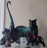 Group of six vintage animal figures and a fish plate, all glazed pottery in greenish tones, including a tall swan, lion, bear, rabbit, and owl plus fish plate on stand