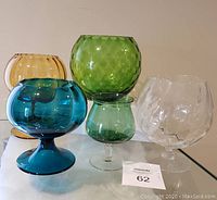 Front view showing all five Empoli style art glass pieces in various colors and shapes.