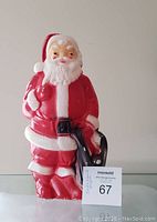 Front view of the vintage Santa Claus blow mold showing the full figure with red suit, white beard, sack and lantern, with clear bright colors and clean condition.