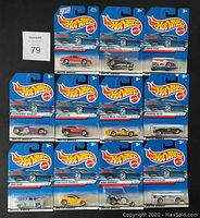 Full lot display showing 11 sealed Hot Wheels car packs from 1999 First Edition series backing with product details and model names.