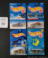 Front view of four Hot Wheels motorcycles in original blister card packaging, showing Scorchin' Scooter name and motorcycle designs.
