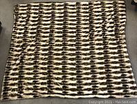 Full view of the large faux fur sleigh robe spread showing its square shape and brown and cream striped faux fur pattern.