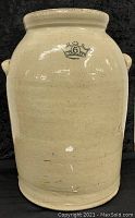 Front view of butter churn crock showing crown symbol with number 6 on beige surface