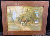 Full view of the framed watercolor painting showing the cow and calf in a rural setting.