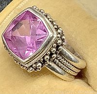 Close-up of the sterling silver ring showing the pink gemstone and beaded silver setting.