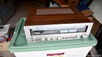 Silver-faced Technics stereo receiver with wood veneer top