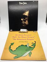 Front covers of Elton John vinyl record and Walt Disney 'Puff the Magic Dragon' vinyl record