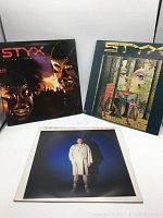 Front covers of three vinyl records: Styx 'The Grand Illusion,' Styx 'Kilroy Was Here,' and George Carlin 'Indecent Exposure.'