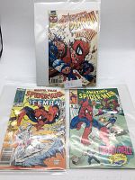 Front view of three Spiderman comic books in protective sleeves on white surface, featuring The Sensational Spiderman, Marvel Tales Spiderman & Iceman, and The Amazing Spiderman Deadball.