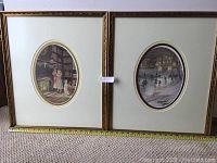 Two side-by-side framed vignettes leaning against a wall on carpet, showing both pieces with white oval mats and ornate gold frames