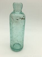 Front view of antique Boyle & Libby Toronto Hutchinson soda bottle showing embossed text and bird emblem.