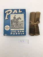 PAL Series jigsaw puzzle box with hunting scene and rolled cloth case tied with fabric string