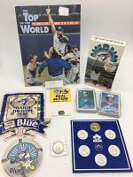 Full lot of vintage Blue Jays collectibles including magazine, VCR, cards, coin holder, and coasters.