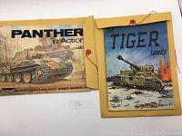 Both war books in yellow button envelopes side by side on a white background, showing front covers.