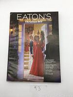 Front cover of Eaton's 1974 Christmas Catalogue depicting a holiday scene with family at the door.