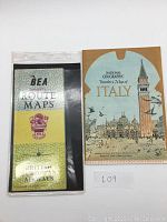 Photo showing the BEA Domestic Route Maps folder with British European Airways crest and the National Geographic Traveler's Map of Italy cover together.