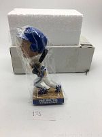 Front view of Paul Molitor bobble head wrapped in plastic with box and styrofoam behind it.