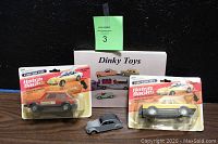 Lot contents showing Dinky Toys 2CV die cast car, Dinky Toys price guide book, and two sealed Tootsie Toy Hatch Backs cars in original packaging.