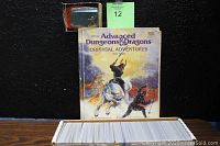 Box of approximately 850 Magic The Gathering cards with D&D Oriental Adventures book and Goblin King figurine behind.