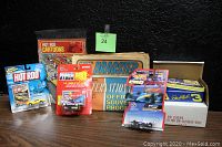 Photo showing the collection of vintage racing magazines and die cast cars boxed and carded.