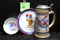 Full view of the Sam the Olympic Eagle porcelain plate and ashtray with the Anheuser Busch beer stein from 1988 Calgary Winter Olympics