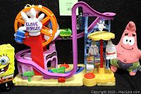 Photo showing full Glove World Playset structure with slide, Glove World Ferris wheel, SpongeBob figure, and Patrick plush toy in front