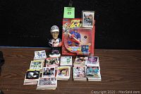 Full view of hockey trading cards, Wayne Gretzky action figure MOC, bobblehead on wooden table