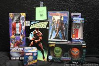 Full lot including Daredevil comic book in bag, boxed Daredevil 2-disc DVD, Guardians of the Galaxy Star-Lord Titan Hero Series figure in box, Star-Lord PEZ dispenser, Masters of the Universe vinyl Dorbz figures and Funko Mystery Minis Captain Marvel bobble-head.