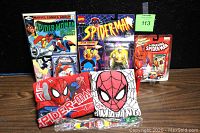 Photo showing the full lot including comic book, action figure, die-cast car, playing cards, watch, two PEZ dispensers, and two children's shirts.