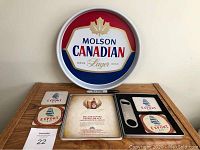 Full lot including Molson Canadian bar tray, Molson Export metal tin with coasters and bottle opener displayed on and around the tray.