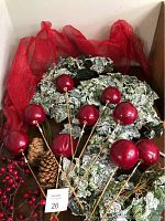 Overview photo showing 4 green frosted decorative swags, 9 red wooden apples on sticks, pine cones, red berries, and red mesh ribbon.