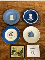 Overview of all four Wedgwood collector plates and the small wooden picture
