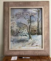 Framed painting of snow-covered trees in a winter scene with a textured beige-pink outer frame and cream inner frame.