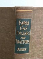 Close-up image of spine of 'Farm Gas Engines and Tractors' book by Jones showing brown cloth cover and green label with gold lettering.
