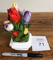 Front view of the multicolored bone china tulip sculpture with Sharpie pen for scale.