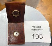 Top view of the open wooden folding compass showing the compass and magnifying glass with Asian characters around them.