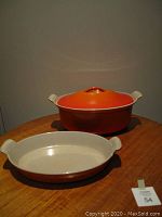 Photo of the covered dish with lid on and the open roasting dish in front, showing the shapes, colors, and condition of the two pieces.