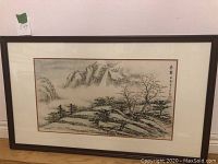 Full view of the framed Chinese watercolor painting showing a misty mountainous landscape with trees and a small house, signed and sealed in upper right with traditional calligraphy.