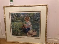 Full view of framed limited edition print by iTrinidad, depicting child with bird in garden.