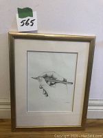 Full view of framed pencil sketch of hand holding pencil