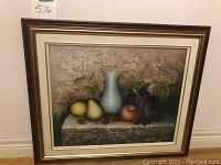 Framed watercolour painting showing full view of art and frame with wall background