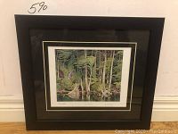 Full view of framed print leaning against wall