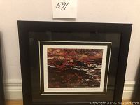 Framed limited edition print titled 'Red Maple' by A. Y. Jackson showing the entire frame and hanging area.
