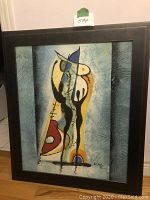 Frontal image of framed original abstract oil painting with abstract human-like forms, dominated by colors blue, yellow, black, white, red and orange.
