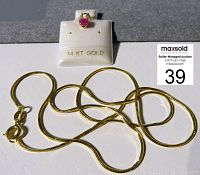 14K gold necklace chain coiled with pendant on a white display labeled 14K gold