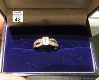 Aquamarine and diamond ring displayed in a blue velvet ring box.