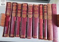 Top-down view of 10 spine titles of vintage classic novels in red bindings with gold embossing.