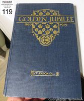 Photo of the front cover of the blue hardcover book with gold embossed title and emblem.