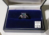 Front view of the mystic topaz silver ring displayed in a jewelry box, showing the square centerpiece stone and the setting.